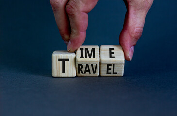 Time to travel symbol. Businessman turns wooden cubes and changes the word 'time' to 'travel' or vice versa. Beautiful grey background, copy space. Business, traveling, time to travel concept.
