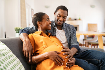 Happy loving pregnant black couple expecting baby