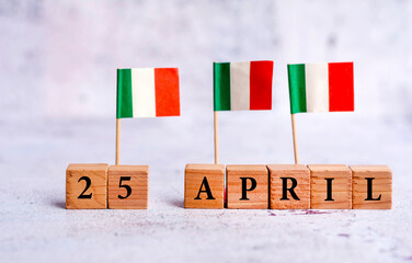 Wooden cubes and miniature Italy flags with the date 25 April .Liberation Day 