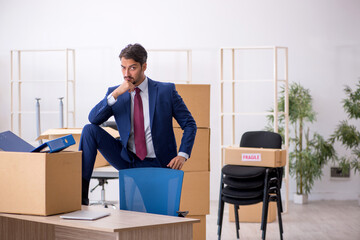 Young male employee in relocation concept
