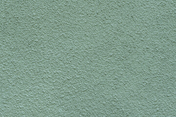 abstract background of painted light green wall close up