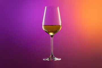 White wine glass isolated over gradient purple and orange color background in neon. Concept of alcohol, holidays, New Year