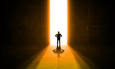 Businessman Standing in Bright Light Door. dark Room with Shiny Stripe way. Business man success and vision Concept 