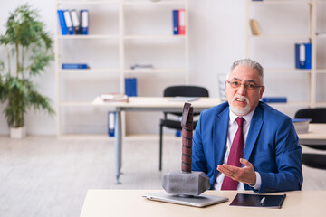 Fototapeta premium Old male employee unhappy with too much work in the office