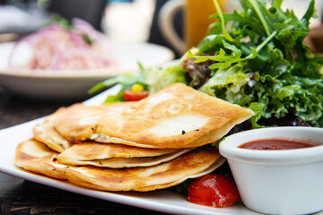 Delicious Mexican beef quesadillas with fresh lettuce and guacamole sauce