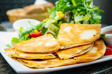 Delicious Mexican beef quesadillas with fresh lettuce and guacamole sauce