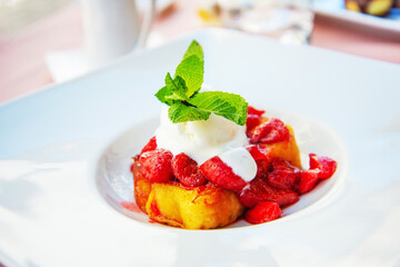 French toast grilled  strawberries and ice cream on top