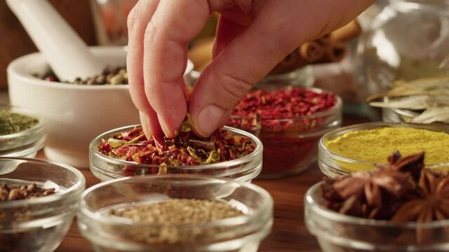 Various spices in glass bowls close-up. Middle eastern and arabian culture. Seasoning and flavors. Pepper, coriander, cinnamon, turmeric, paprika, cumin. Different kinds of dry herbs for cooking. 
