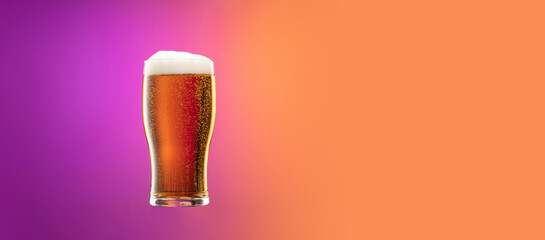 Flyer with full glass of frothy light lager beer isolated over gradient purple and orange color...