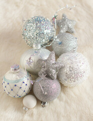 Gray, white and blue Christmas balls on fur background