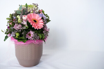 Decorative still life floral composition. Wedding or birthday bouquet of pink and white flowers. White table background. Styled stock photo. 