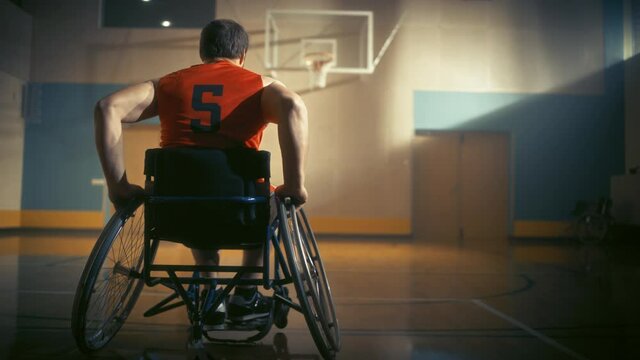 Wheelchair Basketball Player Dribbling Ball Like a Professional, Shooting it Successfully. Determination, Motivation of a Person with Disability Excelling at Team Sport. Back View, Slow Motion