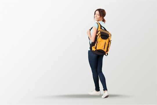 Happy young student posing with a backpack