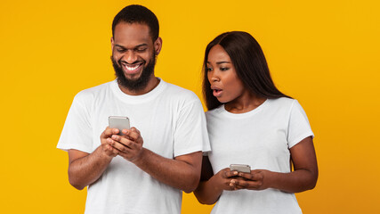 Black woman checking his boyfriend mobile phone