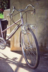 Fototapeta na wymiar front view of vintage bicycle beside old wall