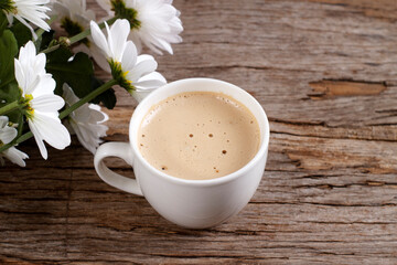 White coffee cup with hot cappuccino with latte on wooden background