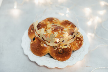 Homemade traditional sweet bread - called in German Dreikönigskuchen or Three Kings Bread - baked in Switzerland on January 6. Person who finds the king inside the bread, gets the crown.