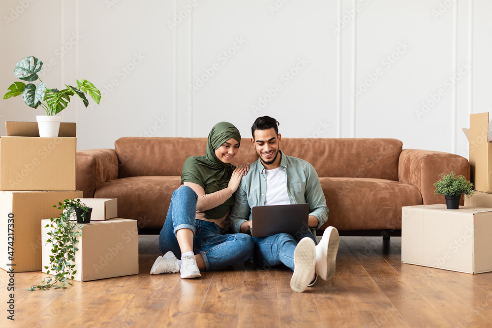 Poster happy man and woman using laptop after relocation