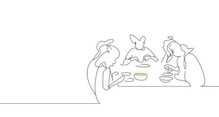 They are happily eating together at a large family dinner table.