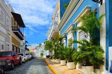 Residential Street of San Juan, Puerto Rico's capital and largest city, sits on the island's Atlantic coast. Cobblestoned Old San Juan features colorful Spanish colonial buildings, with potted plants