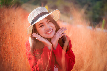 Young Asian woman traveler sightseeing on colored meadows in garden at Khao Kho, Phetchabun, Thailand. Relaxing on vacation concept.