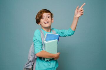 Ginger white boy gesturing while posing with exercise books