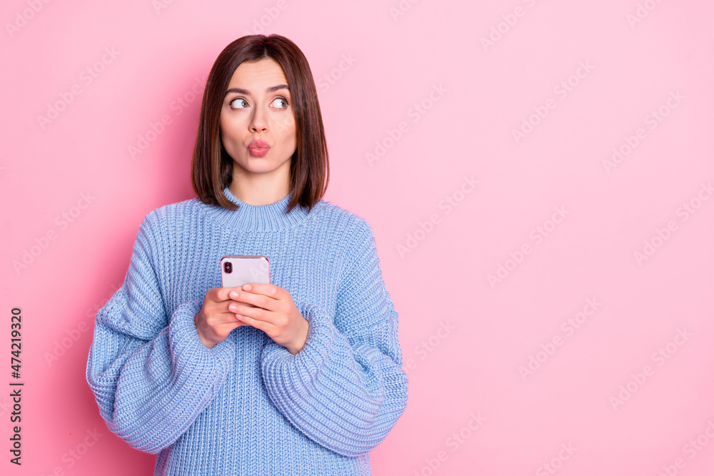 Poster Portrait of attractive minded funky girl influencer using gadget thinking post copy space pout lips isolated over pink pastel color background