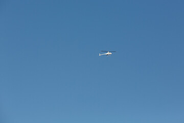 Naklejka na ściany i meble Helicopter against the blue sky.
