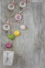 Moscow, Russia, December 2021, background, white cup with wings and multicolored macarons on a light wood background