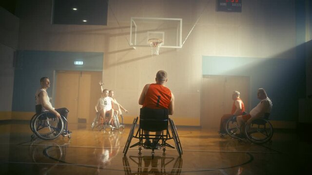 Wheelchair Basketball Game: Professional Players Competing, Dribbling Ball, Passing, Shooting and Scoring a Goal. Celebration of People with Disability. Stylish Cinematic Slow Motion Dutch Angle Shot