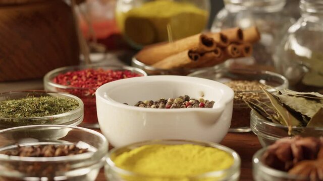 Colourful spices in glass bowls close-up. Middle eastern and arabian culture. Seasoning and flavors. Pepper, coriander, cinnamon, turmeric, paprika, cumin. Different kinds of dry herbs for cooking. 