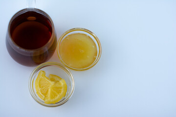 Tea with turmeric among products for improving immunity and treating colds - lemon, honey. Top view, flat lay. Space for text