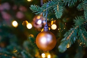 a golden ball on a spruce branch. traditional Christmas decorations. 