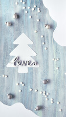 Minimal Christmas panoramic background. Silver baubles, christmas tree, red soft felt snowflakes. Light green textured board, abstract organic shapes. Backdrop for stories about winter holidays.