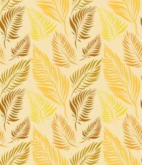 Warm coloured sunny autumn palm leaves pattern on yellow background