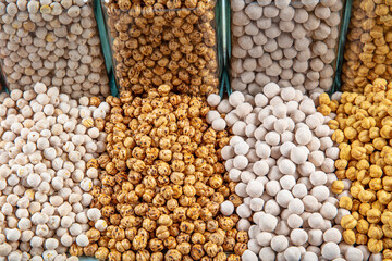 different types of chickpeas in glass jars,white chickpeas,coated chickpeas,sugar coated chickpeas,salty chickpeas.