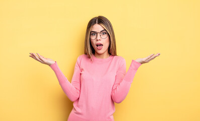 pretty caucasian woman feeling extremely shocked and surprised, anxious and panicking, with a...