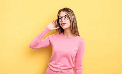 pretty caucasian woman looking serious and curious, listening, trying to hear a secret conversation...