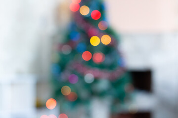 Decorated Christmas tree and fireplace. The photo is out of focus. Christmas background. No focus