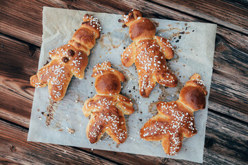Homemade dough men - called in German Grittibänzli - made with sweet yeast dough and covered with decorative sugar. Swiss tradition to bake dough men on December 6 and in Advent time.