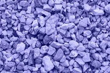 Very Peri. Color of the year 2022. Violet, purple colors. Close-up of crushed gravel as background or texture. Small crushed stones, road metal, material