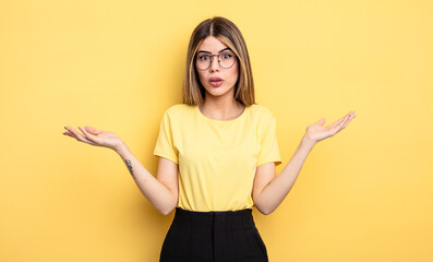 pretty caucasian woman feeling extremely shocked and surprised, anxious and panicking, with a...