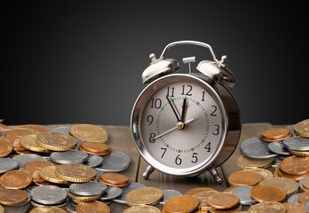 money background, coins and alarm clock on the table, concept of bank deposits,