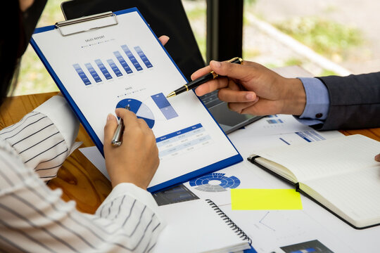 Business people discuss income and performance-based marketing in past meetings, financial advisors analyze data with investors, business ideas working with a team of colleagues and market planners.