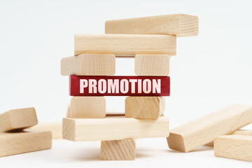 On the white surface there is a ruined tower made of planks, on a red plaque there is an inscription - PROMOTION