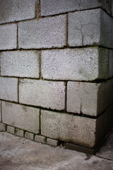 Grey cinder block wall with wet seams. Perspective view