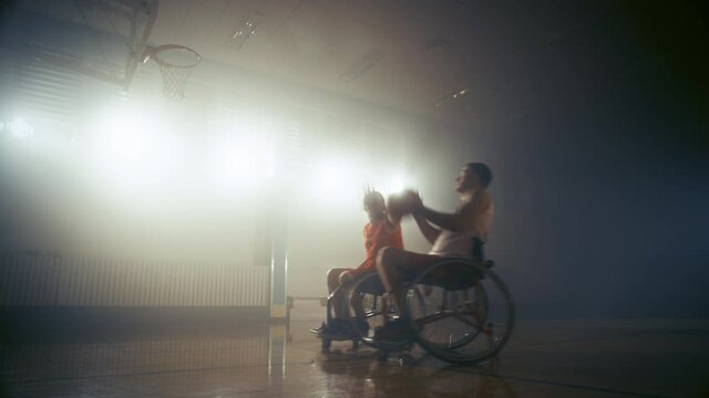Wheelchair Basketball Game One on One: Professional Players Competing, Dribbling, Shooting it but Missing the Basket. Determination, Skill and Training of People with Disability. Slow Motion
