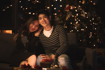 young Asian couple in night celebration with romantic love together, happy holiday Christmas party