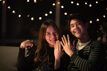 young Asian couple in night celebration with romantic love together, happy holiday Christmas party