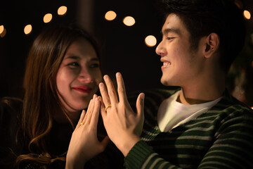 young Asian couple in night celebration with romantic love together, happy holiday Christmas party